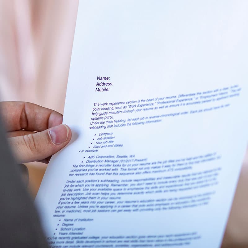 Internal team member reviewing a printed resume